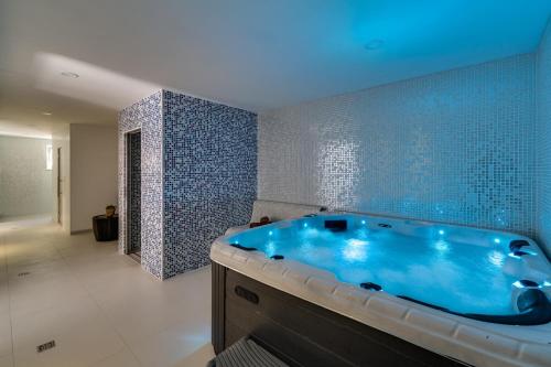 珀德垂那Luxury Villa Lucas with heated pool, whirlpool, sauna, 14 pax的一间位于客房内的带大型蓝色浴缸的浴室