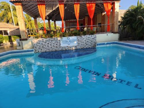 Gonaïvesodivin hotel luxury suite的蓝色海水度假村的游泳池