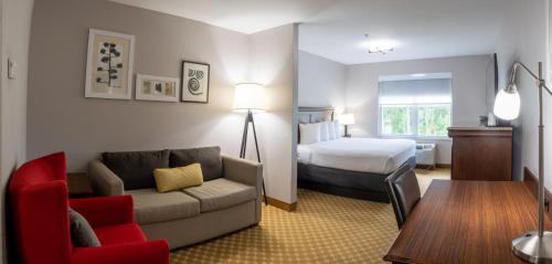威尔明顿江山旅馆 - 威尔明顿机场/会展中心的酒店客房,配有床和沙发