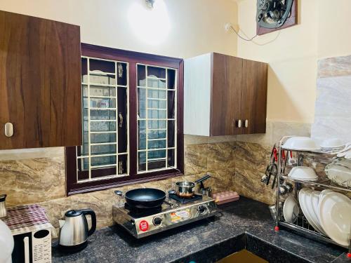 海得拉巴Prince Castle-2BHk Luxurious Apartment/Guesthouse的厨房配有木制橱柜和炉灶烤箱。