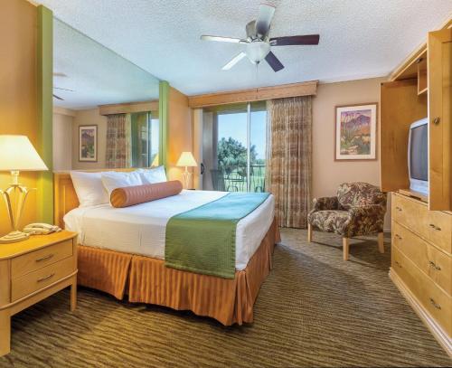 棕榈泉WorldMark Palm Springs - Plaza Resort and Spa的酒店客房,配有床和电视
