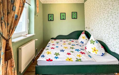 Stubbenfelde1 Bedroom Stunning Apartment In Klpinsee-usedom的小卧室配有一张带花卉床罩的床