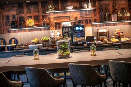布鲁塞尔布鲁塞尔万豪行政公寓的餐厅设有一张大型木桌和椅子