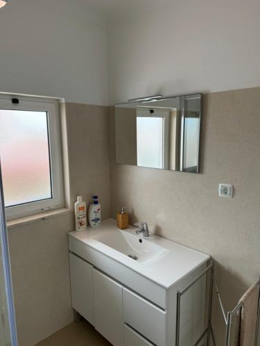 奥德米拉Cabo Sardão Guest House的浴室设有白色水槽和镜子