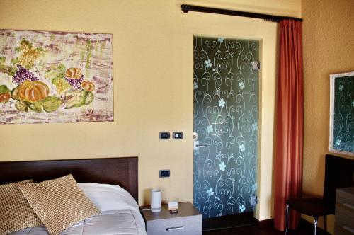 博洛尼亚Podere Boschetto R&B的卧室配有一张床,墙上挂有绘画作品