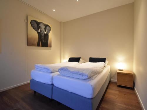 泽伊德沃尔德Vrijzicht的一间卧室配有两张床,一张大象的照片