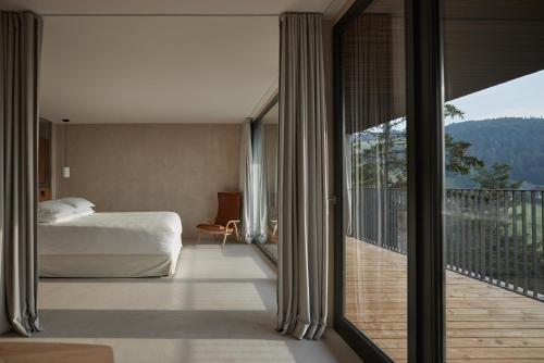 圣杰内肖阿泰西诺Saltus的一间卧室设有一张床和一个美景阳台