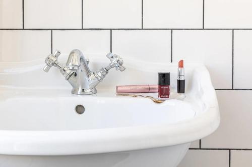 巴黎巴斯酒店的浴室水槽,上面有唇膏和化妆品