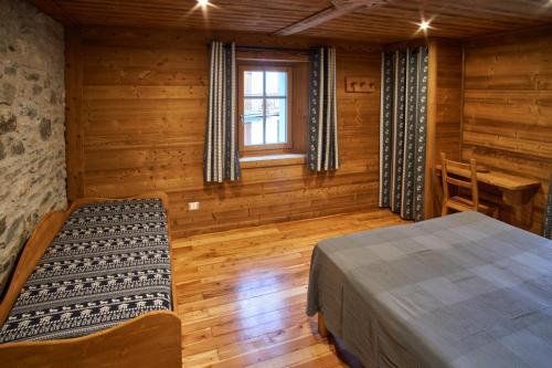 科涅Chalet du Paradis的小木屋内的卧室,配有床和窗户