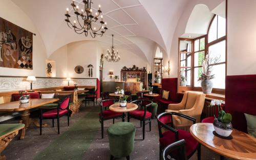 奥蒂塞伊阿姆斯塞特奈克经典酒店的一间带桌椅和吊灯的餐厅