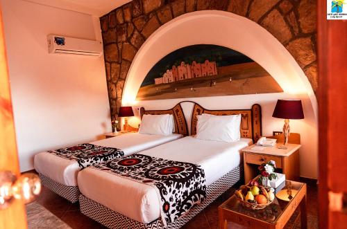 阿布辛贝塞提阿布辛贝湖度假酒店的酒店客房设有两张床和一张桌子。