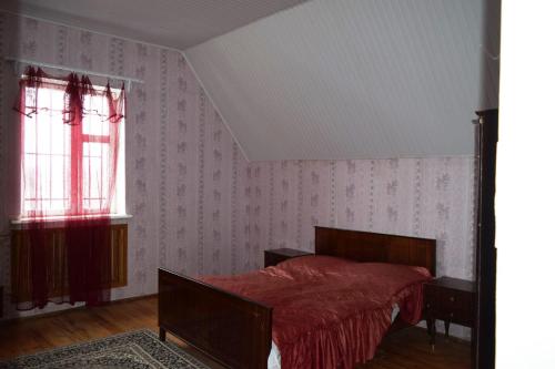 久姆里Вила Eco Garden的一间卧室配有一张带红色毯子的床和窗户。