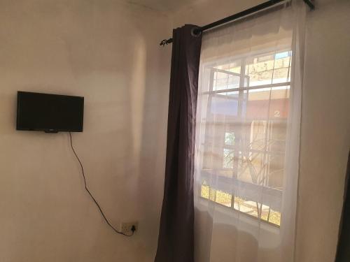 MeruFaraja的窗帘窗户和墙上的电视