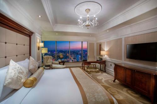 贵阳贵阳凯宾斯基大酒店的一间酒店客房,配有一张大床和一台平面电视