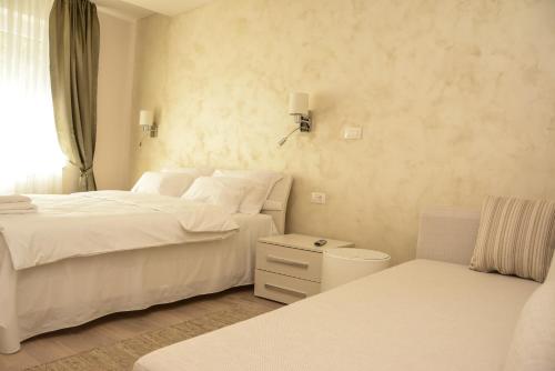 沙巴茨Apartment Venera A&M的白色卧室配有两张床和椅子
