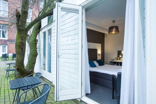 阿姆斯特丹福索冯德尔公园酒店的一间设有床、窗户和树的房间