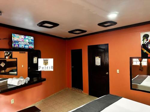 Santa Cruz TecamacPaléis的一间拥有橙色墙壁和电视的等候室