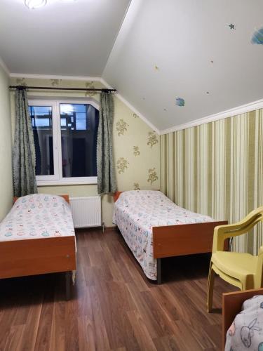 乌曼岛Guest house的一间卧室设有两张床和窗户。