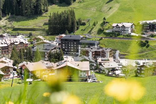 塞尔瓦迪加尔代纳山谷Stella Hotel - My Dolomites Experience的山丘上一座拥有房屋的小城镇