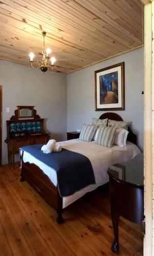 帕特森The Wild Olive Sanctuary Accommodation的一间卧室设有一张床和木制天花板