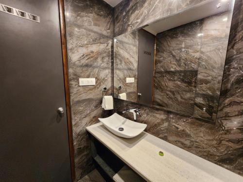 西姆拉The Golden Hotel的一间带水槽和镜子的浴室