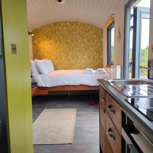 特拉利DANÚ Shepherd's Hut的一间卧室配有一张黄色墙壁的床