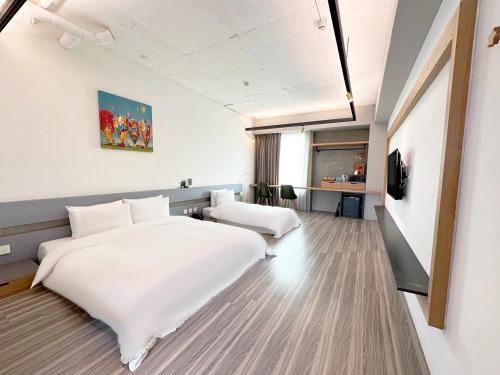 莺歌区私客创旅 的酒店客房设有一张白色大床和一张书桌