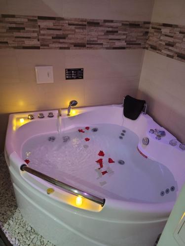 富萨加苏加Hotel Ocean Fusagasuga的白色浴缸内有红色的心