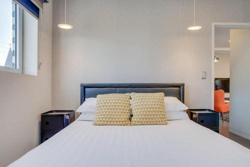 悉尼Cosy 1-Bedroom Apartment Close to the City的一间卧室配有一张带两个枕头的床