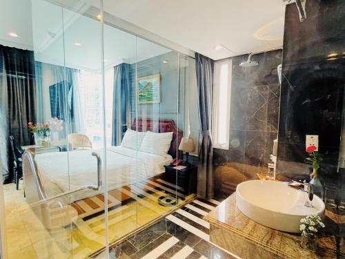 河内Le Grand Hanoi Hotel - The Sun的一间带床、浴缸和水槽的浴室