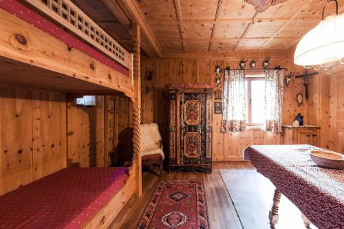 雷西亚Chalet am Reschensee的木制客房内的1间带1张双层床的卧室