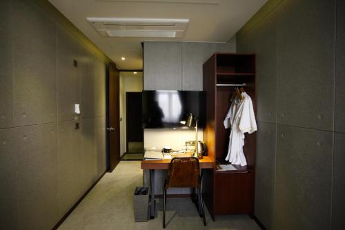首尔明洞多玛酒店的一间客房内配有桌子和椅子的房间