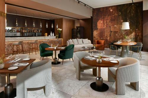 塞维利亚塞维利亚NH酒店集团的一间带桌椅的餐厅和一间酒吧