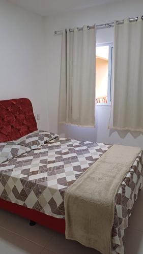 瓜拉久巴LAZER EM GUARAJUBA的一间卧室配有一张大床和一张 ⁇ 子毯子