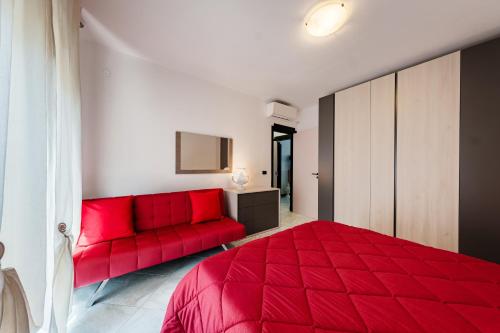 莫诺波利Casa Nilla的一间卧室配有红色的床和红色的沙发
