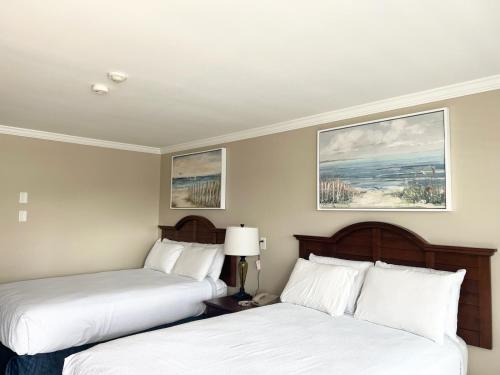 西雅茅斯Cape Cod Family Resort and Parks的配有白色床单的酒店客房内的两张床
