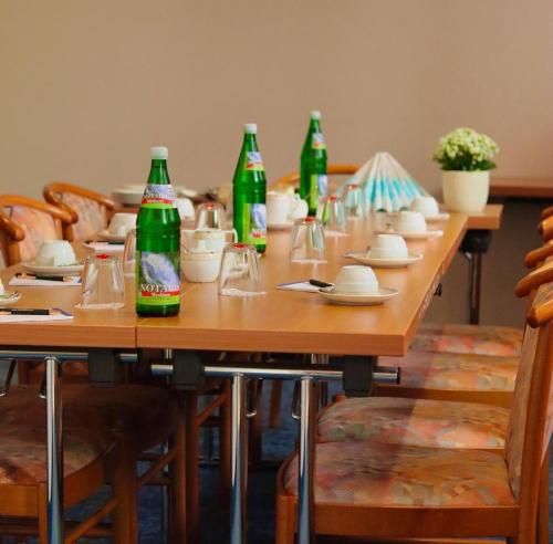 科隆依贝茨嘉利酒店的一张长木桌子和苏打水瓶