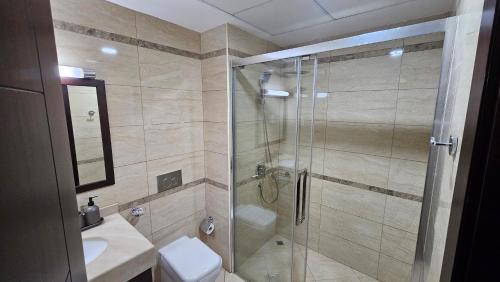 拉斯阿尔卡麦Luxury villa 4 bedroom with pool access的带淋浴、卫生间和盥洗盆的浴室