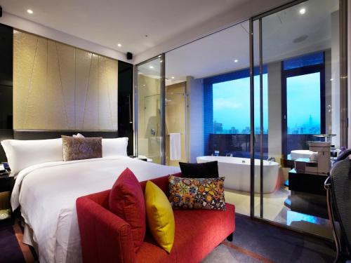 台北天阁酒店台北长安的一间卧室设有一张大床和一个浴缸
