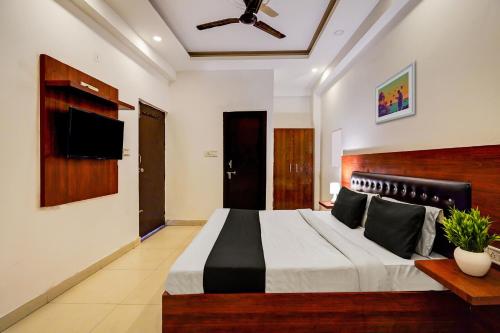 新德里Hotel Franklein Suites At Delhi Airport的一间卧室配有一张大床和一台平面电视