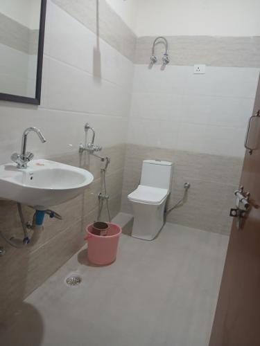 古尔冈Star stay的白色的浴室设有水槽和卫生间。