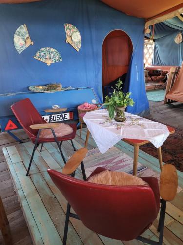 布莱德Nomads House的配有桌椅和蓝色帐篷的房间