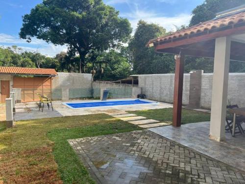 Embu-GuaçuCasa com piscina Embu-Guaçu/ Itapecerica (Chácara)的后院设有游泳池和庭院