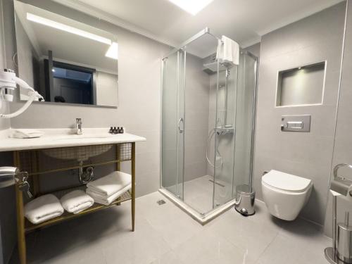 伊兹密尔The Yalı Konak Hotel İzmir的带淋浴、盥洗盆和卫生间的浴室