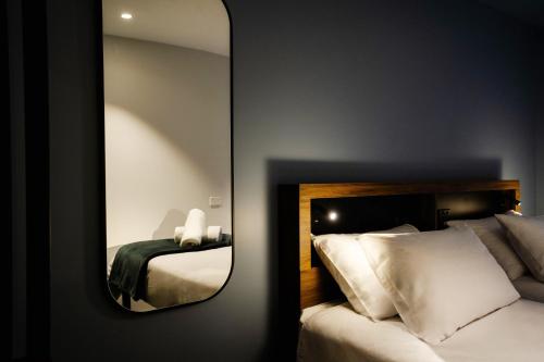 特卡波湖Haka House Lake Tekapo的一张镜子,位于酒店带一张床的房间里