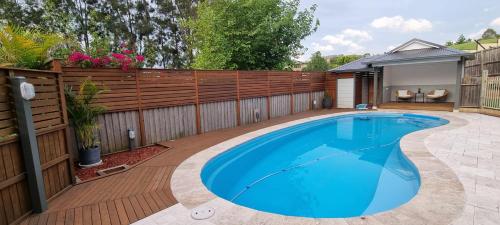 Guest Studio in Campbelltown的后院的游泳池,带有木栅栏