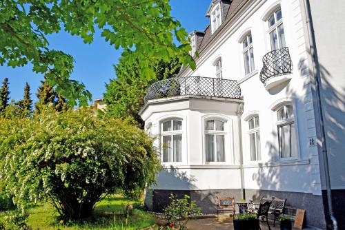 巴贝Villa im Ostseebad Baabe的白色的建筑,上面设有阳台