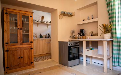 MartinovoГагинската къща的厨房配有木制橱柜和炉灶烤箱。