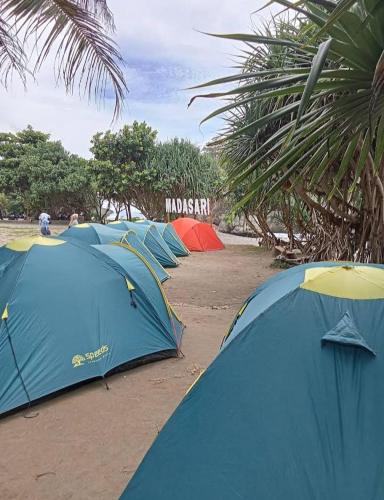 BulakbendaMadasari Outdoor Camping Tenda Paket Hemat的海滩上排成一排帐篷