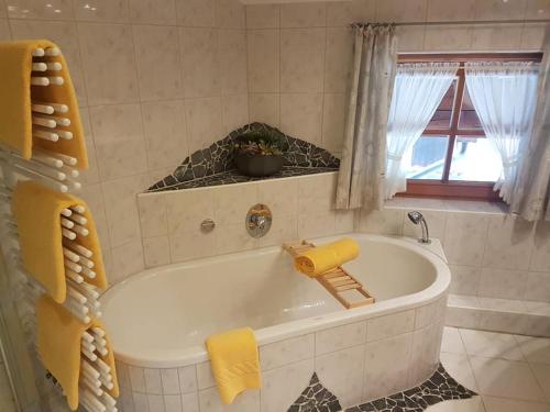 雷特温克尔Zum Eichhof的带窗户的浴室内的白色浴缸
